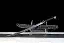 Iron Reaper Tactical Dao — high-carbon steel, Black textured handle, black ribbed polymer sheath with clip.